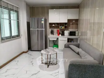 Modern compact kitchen with sleek appliances and cozy living area