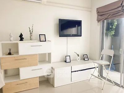 Modern living room with minimalist decor and wall-mounted TV