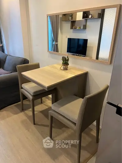 Modern living room with stylish dining area and wall-mounted TV, perfect for cozy urban living.
