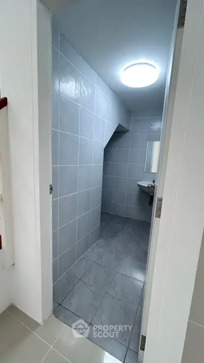 Modern bathroom with sleek gray tiles and minimalist design