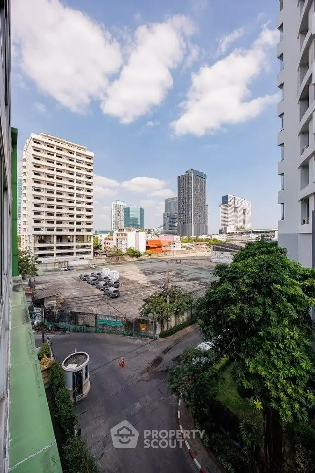 Urban cityscape view with high-rise buildings and open construction site.