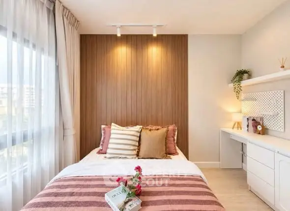 Cozy bedroom with stylish decor and natural light, perfect for relaxation and comfort.