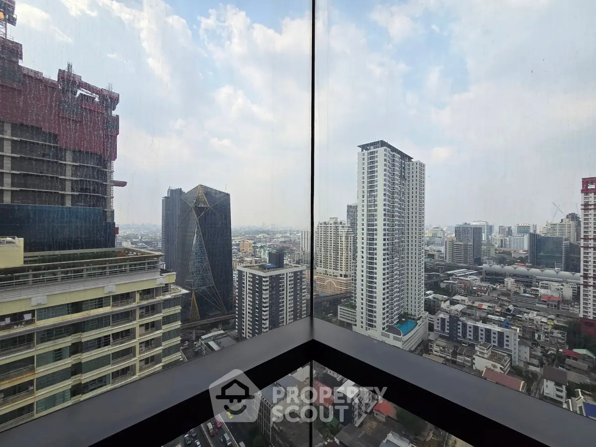 Stunning cityscape view from a high-rise balcony with modern skyscrapers and urban skyline.