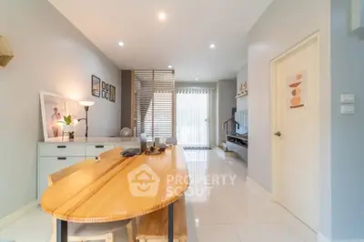 Modern living room with wooden dining table and stylish decor