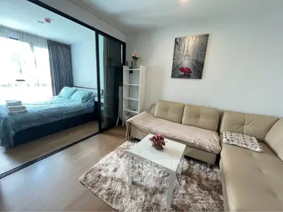 Modern living room with cozy sofa and stylish decor adjacent to a bright bedroom.
