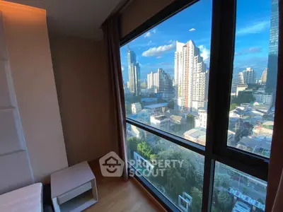 Stunning city view from high-rise apartment window with modern interior design.