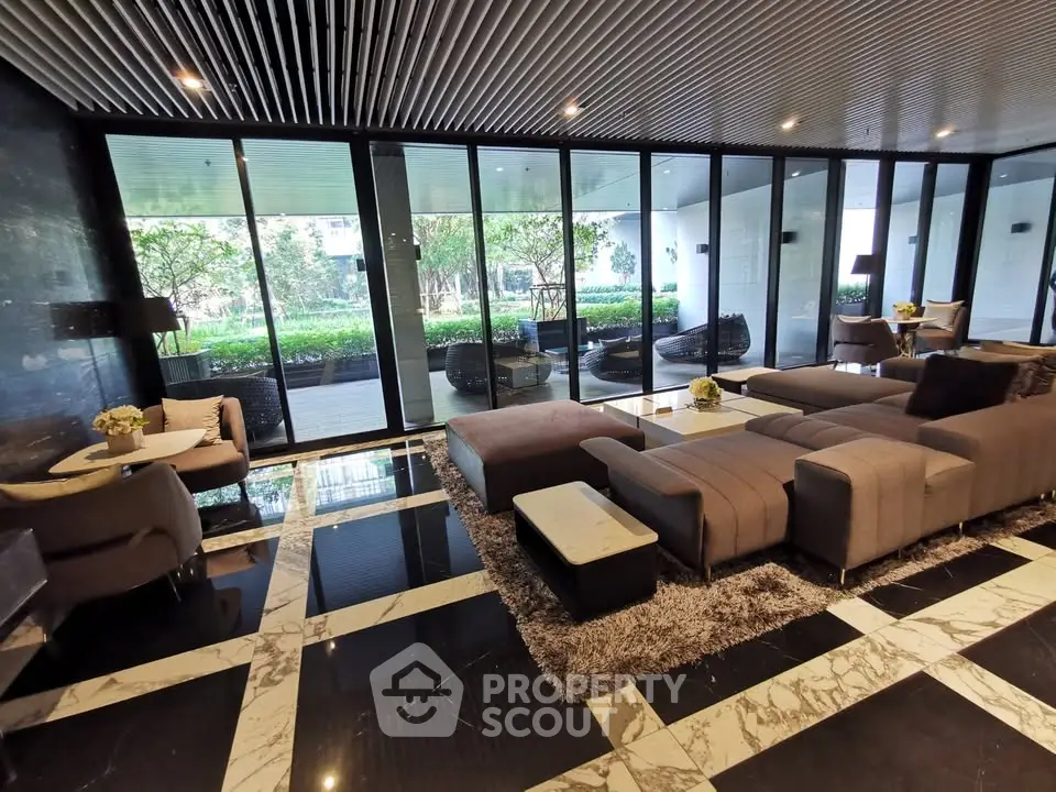 Luxurious modern living room with floor-to-ceiling windows and stylish furniture overlooking a lush garden.