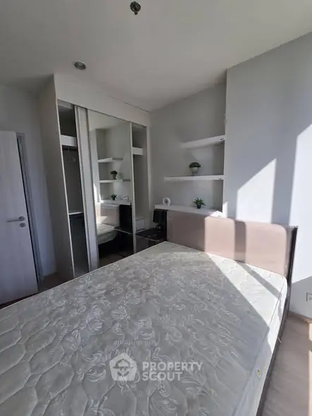 Modern bedroom with built-in closet and natural light