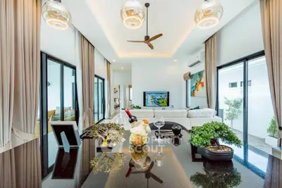 Luxurious modern living room with elegant decor and ample natural light.