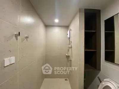 Modern minimalist bathroom with sleek shower and built-in shelving