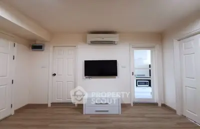 Modern living room with minimalist decor and wall-mounted TV
