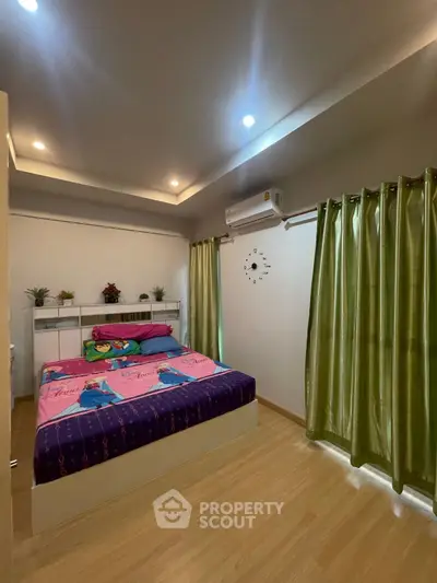 Cozy bedroom with modern decor, featuring a comfortable bed and stylish curtains.