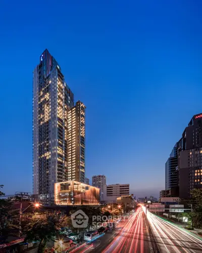 Stunning high-rise building with cityscape view at dusk, showcasing modern urban living.