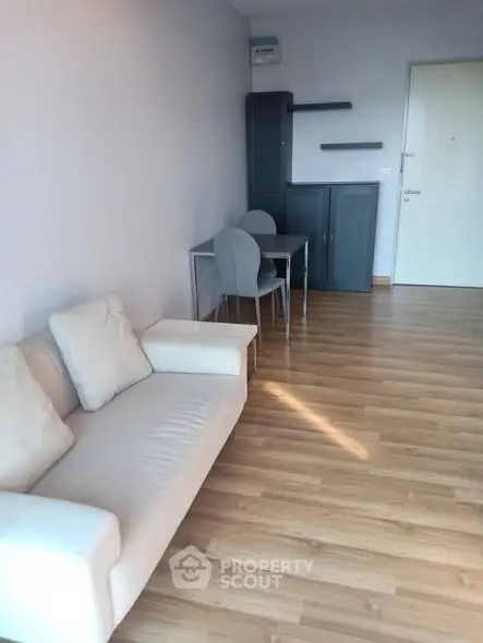 Modern living room with sleek wooden flooring and minimalist furniture design.