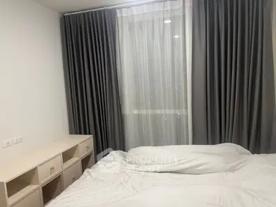 Cozy bedroom with soft lighting and elegant curtains, perfect for restful nights.