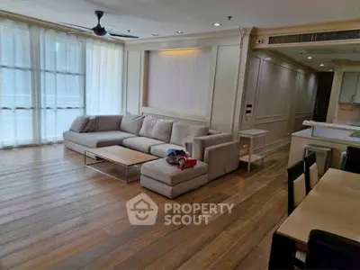 Spacious modern living room with elegant wooden flooring and cozy sectional sofa.