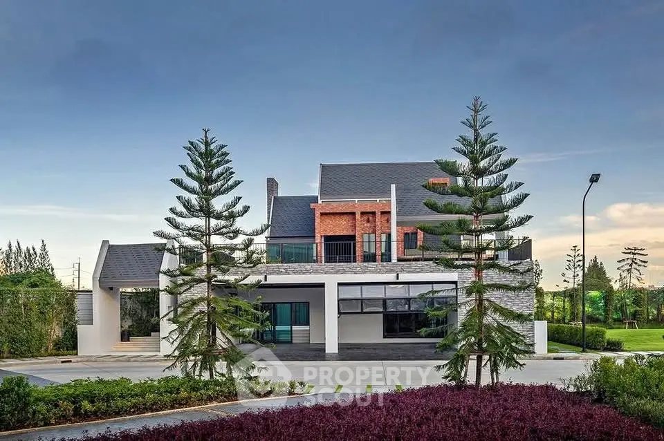 Stunning modern house with lush landscaping and unique architectural design.