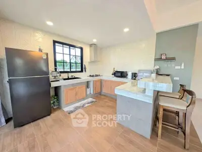 Modern kitchen with open layout, featuring sleek appliances and stylish countertops, perfect for culinary enthusiasts.