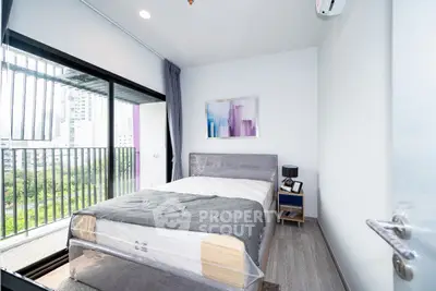 Modern bedroom with balcony view in urban apartment