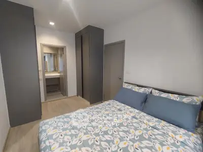 Modern bedroom with stylish bedding and sleek wardrobe design