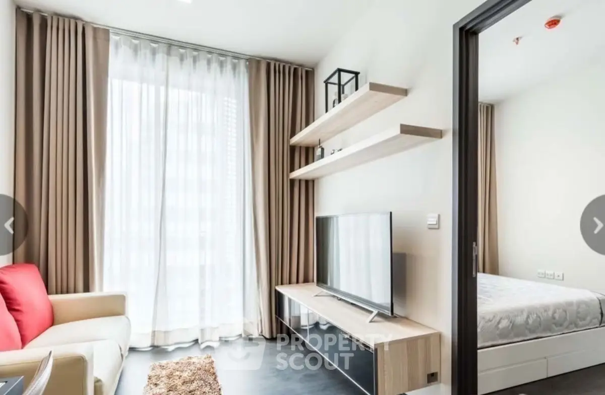 Modern living room with sleek TV unit and cozy bedroom view