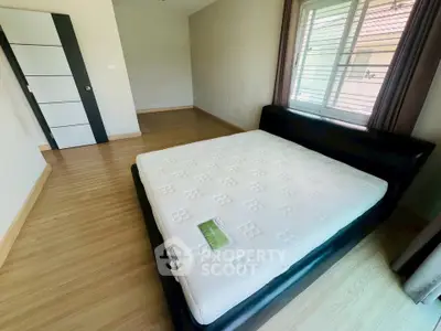 Spacious bedroom with modern design and large window for natural light