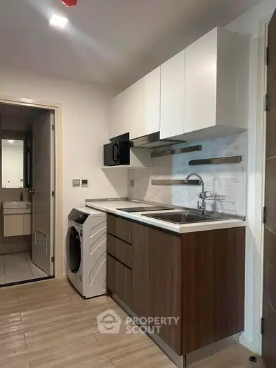 Modern kitchen with sleek cabinetry and integrated appliances in a stylish apartment.