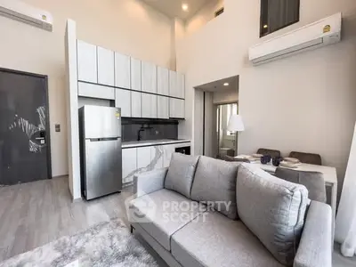Modern open-plan living room with sleek kitchen and dining area