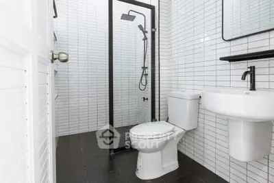 Modern bathroom with sleek black shower frame and white tiles