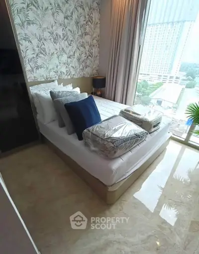 Luxurious bedroom with floor-to-ceiling windows and elegant decor in high-rise apartment.