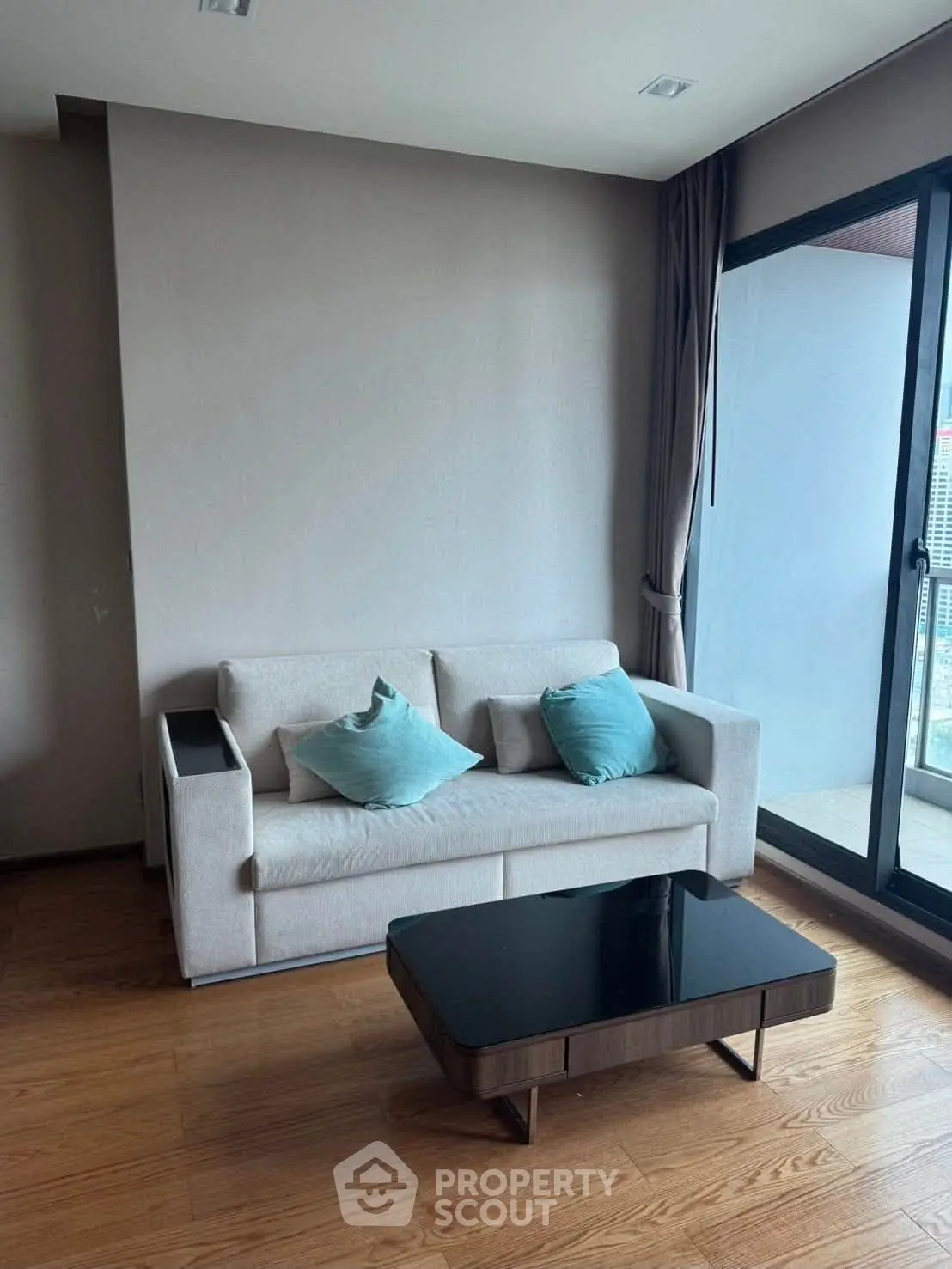 Modern living room with sleek sofa and glass door balcony view