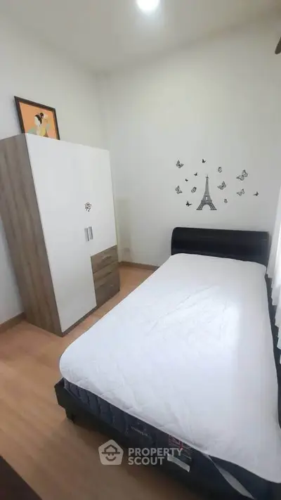 Cozy bedroom with minimalist decor and Eiffel Tower wall art