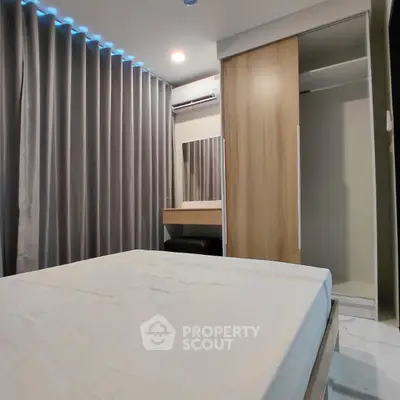 Modern bedroom with sleek design, featuring a large bed, built-in wardrobe, and stylish curtains.