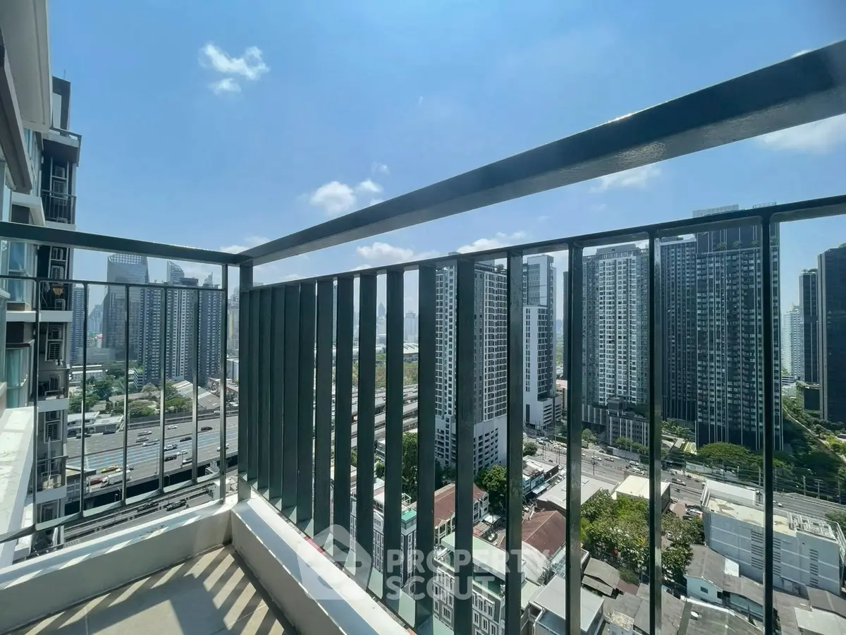 Stunning cityscape view from a high-rise balcony in a modern urban setting.