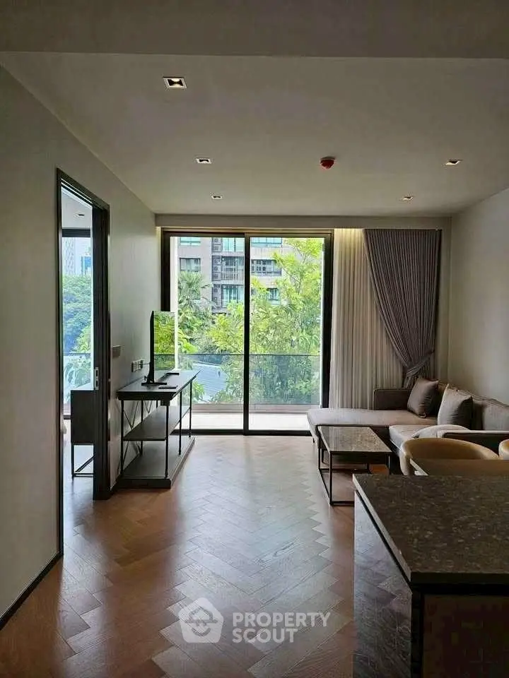 Modern living room with large windows and scenic view, featuring stylish furniture and elegant decor.