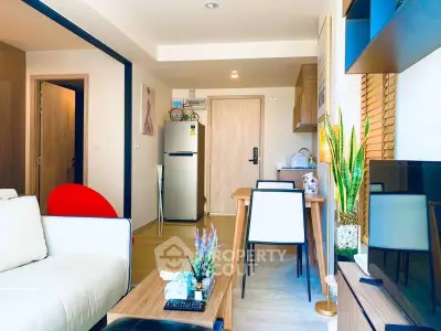 Modern living room with stylish decor and open layout, featuring a cozy seating area and dining space.