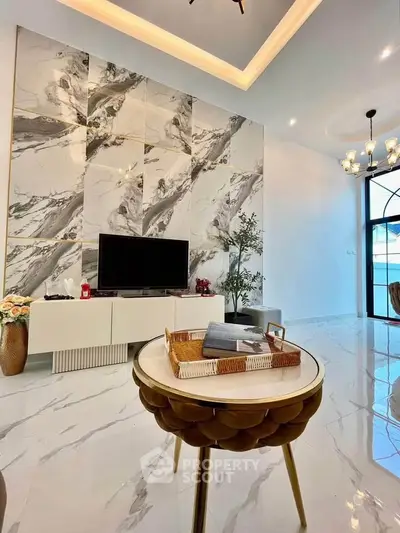 Luxurious modern living room with marble accent wall and elegant decor
