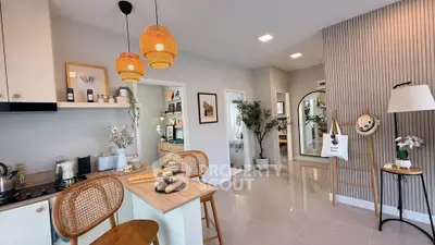 Modern open-plan kitchen and living area with stylish decor and natural lighting.