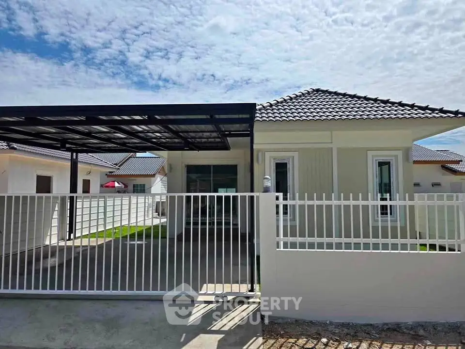 Charming single-story home with modern design and covered carport in a serene neighborhood.
