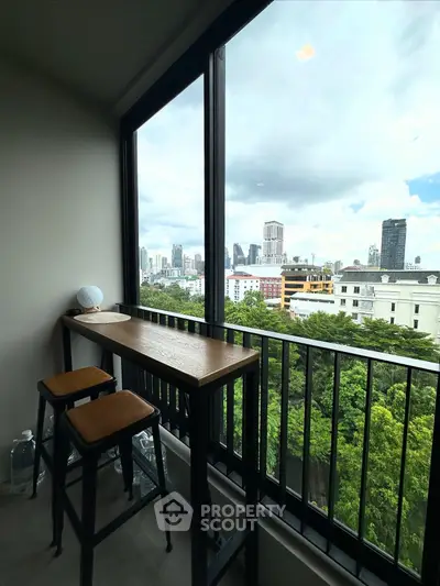 Stunning city view from a modern balcony with bar seating, perfect for relaxation.