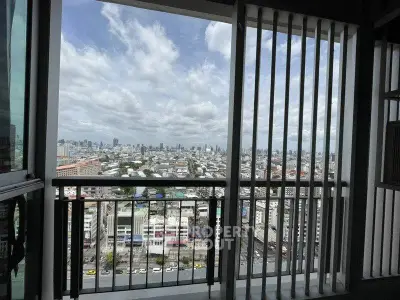 Stunning cityscape view from high-rise balcony with modern railing design.