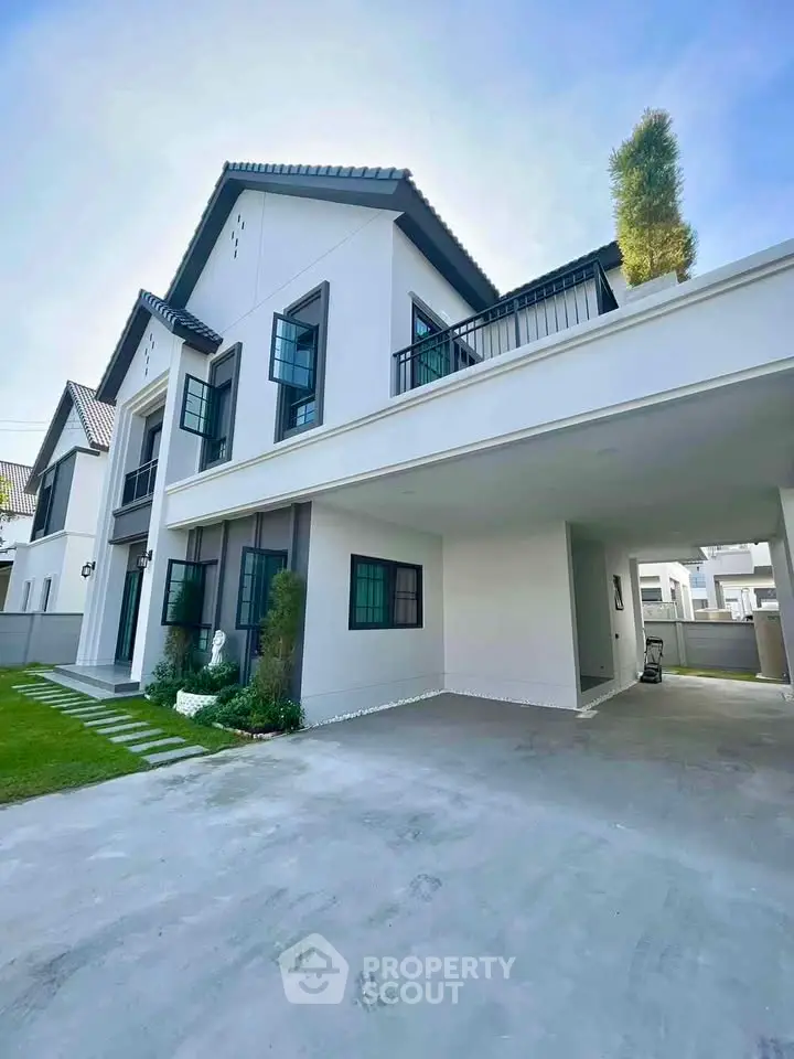 Modern two-story house with spacious driveway and lush green lawn