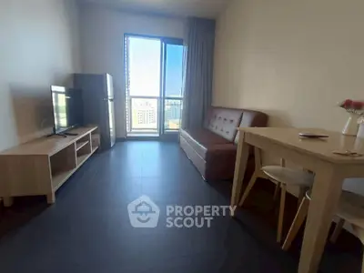 Modern living room with sleek furniture and city view from large window.