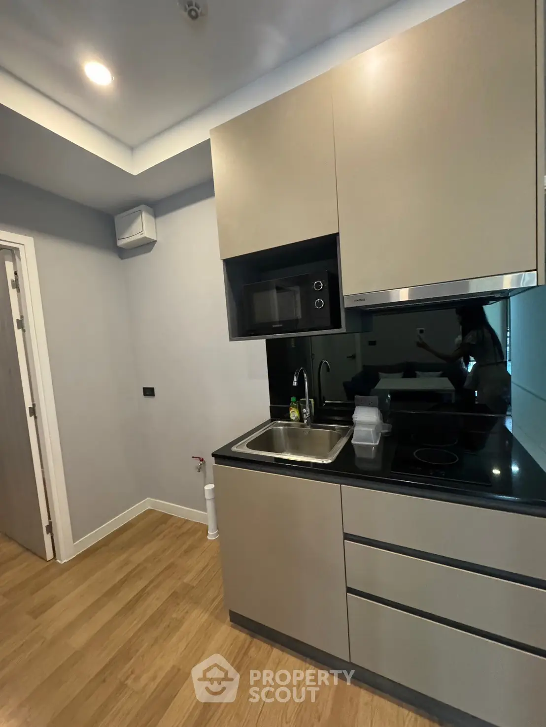 Modern compact kitchen with sleek cabinetry and built-in appliances