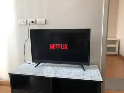 Modern living room with sleek TV setup and stylish furniture, perfect for entertainment enthusiasts.