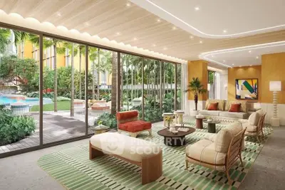 Luxurious living room with floor-to-ceiling windows overlooking a lush garden and pool area.