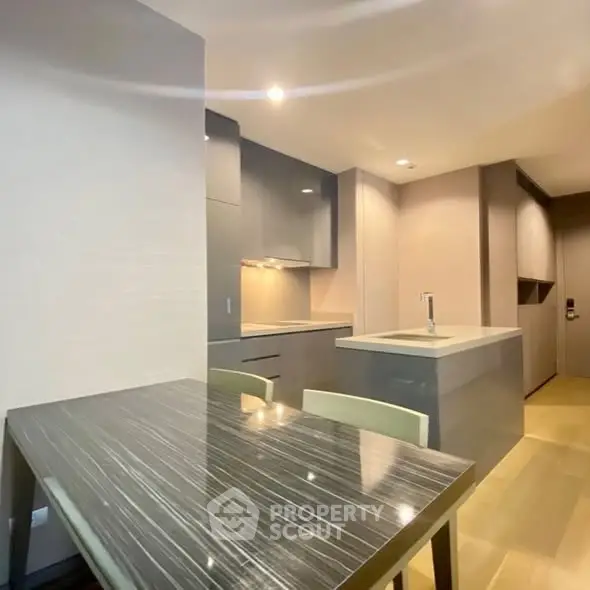 Modern kitchen with sleek cabinetry and dining area in open layout