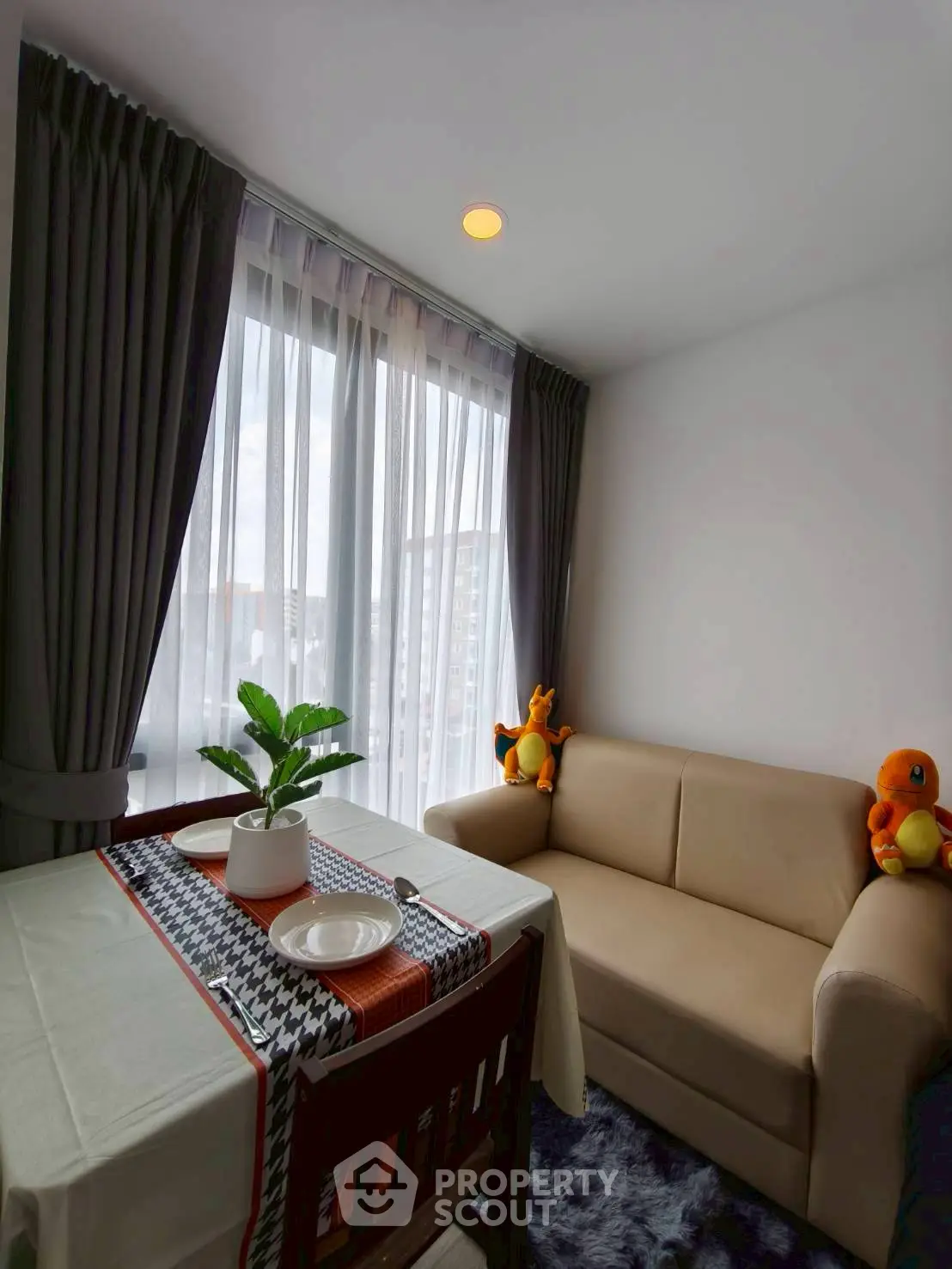 Cozy living room with plush sofa and dining table near large window