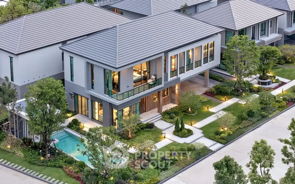 Luxurious modern house with landscaped garden and private pool in upscale neighborhood.
