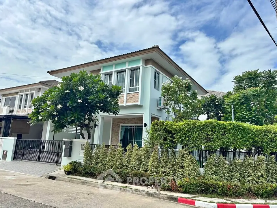 Charming two-story house with lush greenery and modern design in a serene neighborhood.